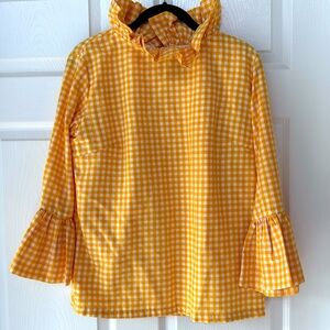 Yellow and white checked blouse with ruffles at neck and sleeves